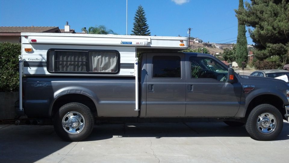Side view of gray pickup truck with camper shell, 2008 model
