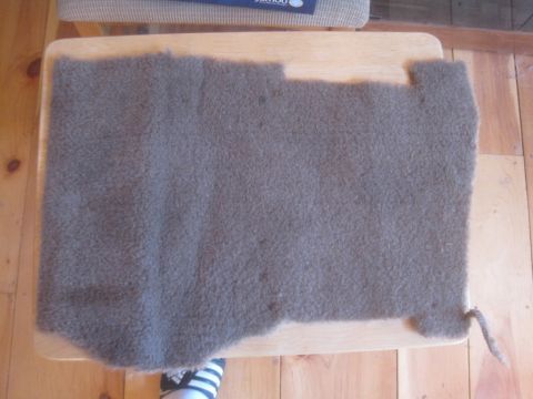 1993 Ford Bronco - A carpet piece is shown, likely from a vehicle's interior, placed on a wooden table.