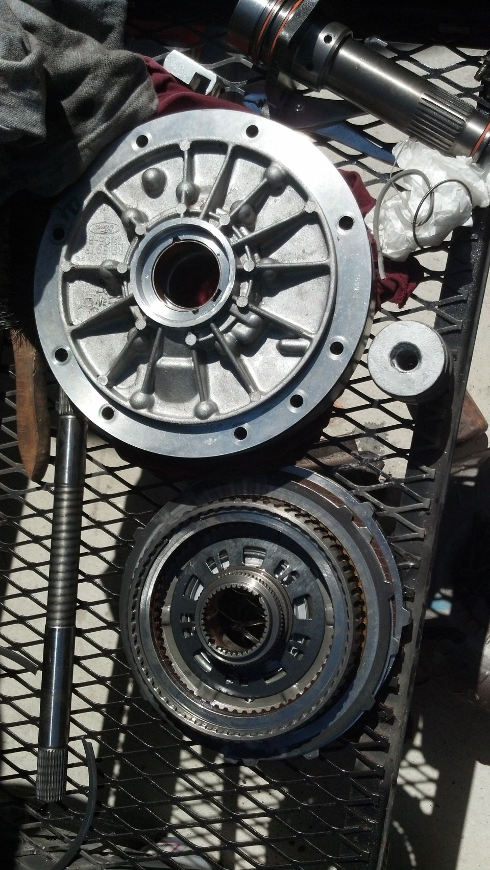 Transmission pump housing and planetary gear set on a metal grate