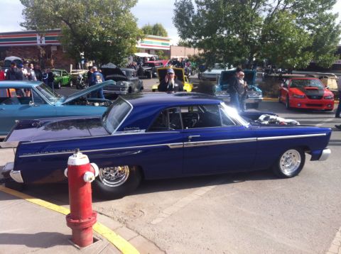 1965 Ford Fairlane - A blue 1965 Ford Fairlane 500 coupe is parked at an outdoor car show event.