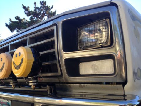 1986 Ford Bronco - This vehicle features a chrome grille and custom smiley face "Daylighter" fog lights mounted on a brush guard.