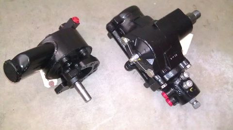 1996 Ford Bronco - Two power steering gears are shown side-by-side on a light-colored surface.