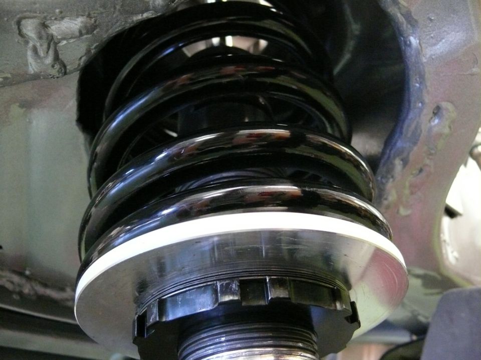 Front suspension coilover shock absorber with black spring and adjustable collar