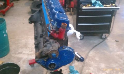 1983 Ford Bronco - Engine on a stand, likely undergoing rebuild or repair in a workshop setting.