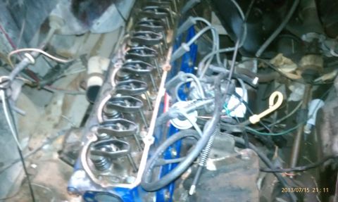 1983 Ford Bronco - Close-up view of an engine bay with valve covers off, revealing internal mechanical parts and electrical wiring.