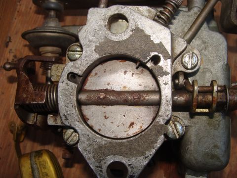 1983 Ford Bronco - This is a close-up view of a carburetor, showing its internal components and signs of wear.