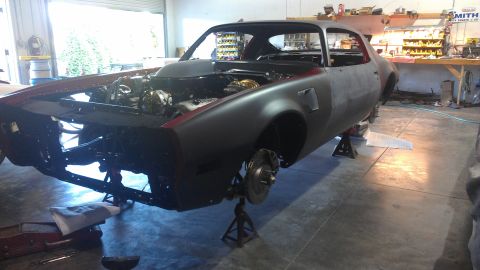 1972 Pontiac Trans Am - This car body, appearing to be from the early 1970s, is in a workshop undergoing restoration.