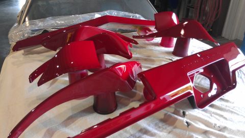 1972 Pontiac Trans Am - Freshly painted car parts drying on a workbench.