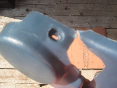 1993 Ford Bronco - This is a blue plastic car part, possibly from a 1993 Ford Bronco, showing a hole and a crack. The part is viewed up close.