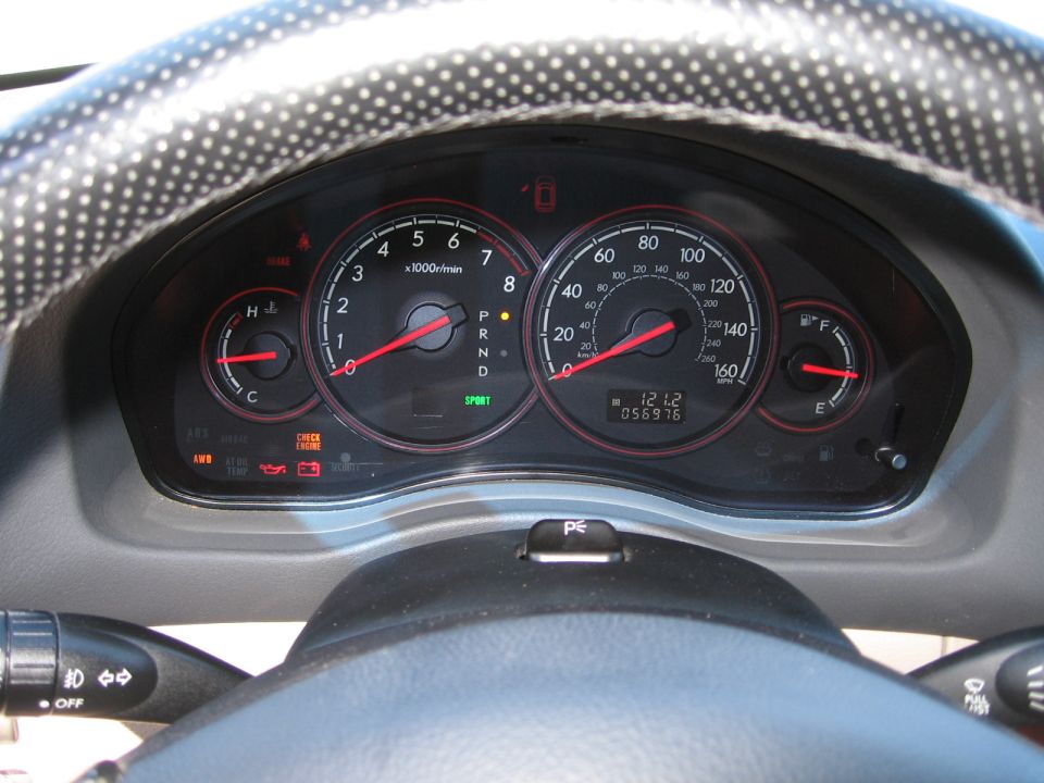 Dashboard gauges with tachometer, speedometer, fuel gauge, and odometer showing 056976