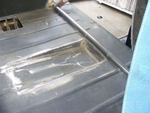 Interior floor with roll bar and blue seat fabric
