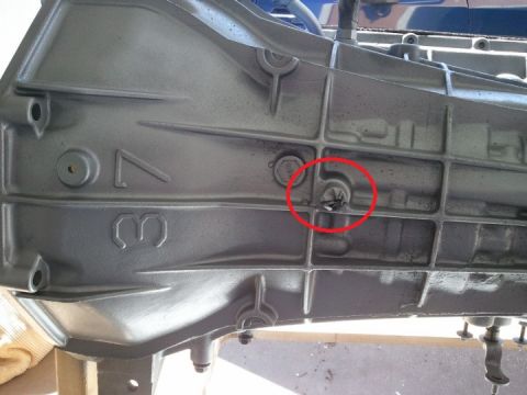 1994 Ford Bronco - This photo shows a close-up of a vehicle's transmission housing, with a red circle highlighting a plug.