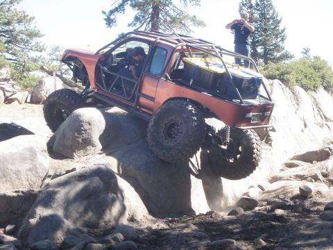 1961 International Scout 800 - This heavily modified off-road vehicle navigates a challenging rocky terrain.