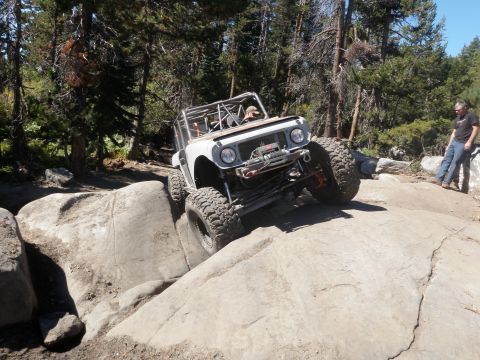 1961 International Scout 800 - This modified 1961 International Scout 800 tackles a challenging rocky obstacle on an off-road trail.