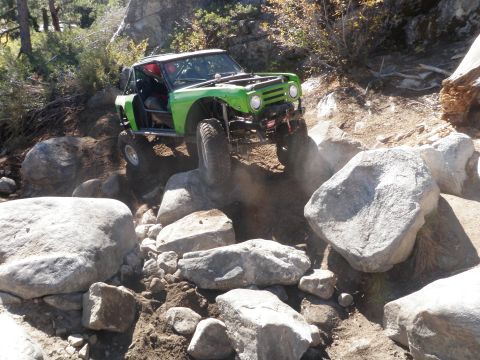 1961 International Scout 800 - Modified 1961 International Scout 800 navigates a challenging rocky terrain on an off-road trail.