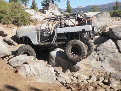 1961 International Scout 800 - This heavily modified off-road vehicle navigates a challenging rocky trail.