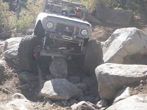1961 International Scout 800 - This 1961 International Scout 800 navigates a challenging rocky trail, demonstrating its off-road capabilities.