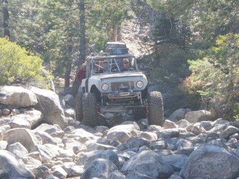 1961 International Scout 800 - Modified 1961 International Scout 800 navigates a challenging rocky trail, with another vehicle visible behind it.