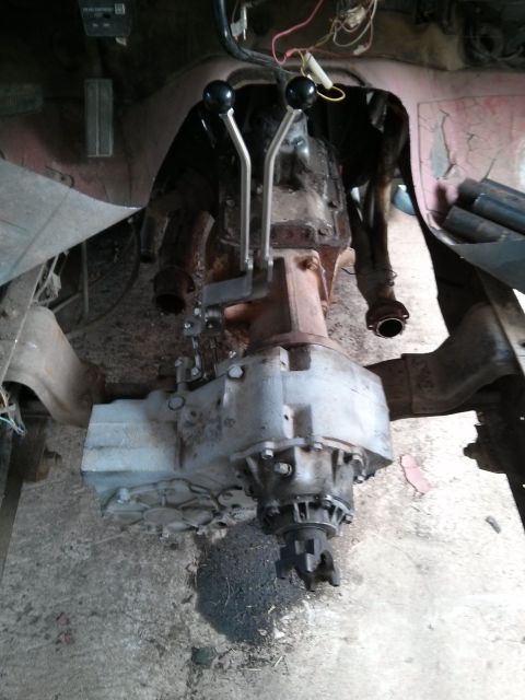 1986 Ford Bronco - Close-up view of a vehicle's transmission and transfer case assembly, dual shifters.