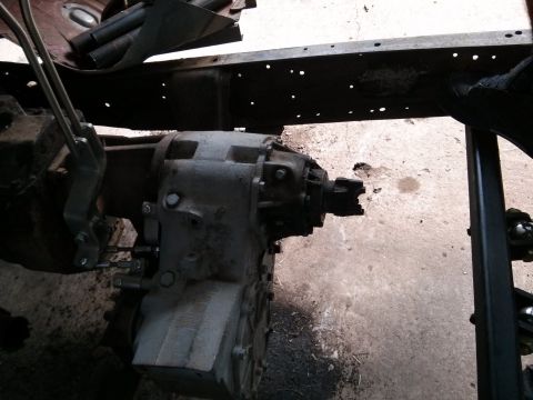 1986 Ford Bronco - Close-up view of vehicle drivetrain components, including a transfer case and transmission.