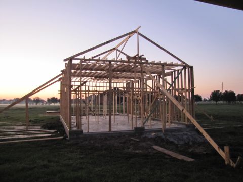 1995 Ford Bronco - The wooden frame of a house is visible against the dawn sky.