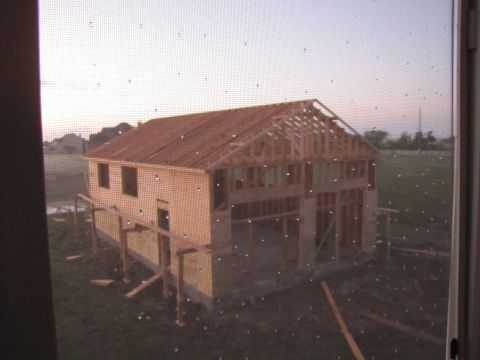 1995 Ford Bronco - A house is seen in its early stages of construction, with the wooden frame and roof structure exposed.