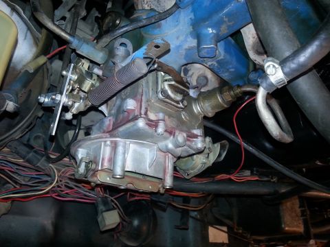1982 Jeep Wagoneer - Close-up view of engine components including a carburetor and wiring.