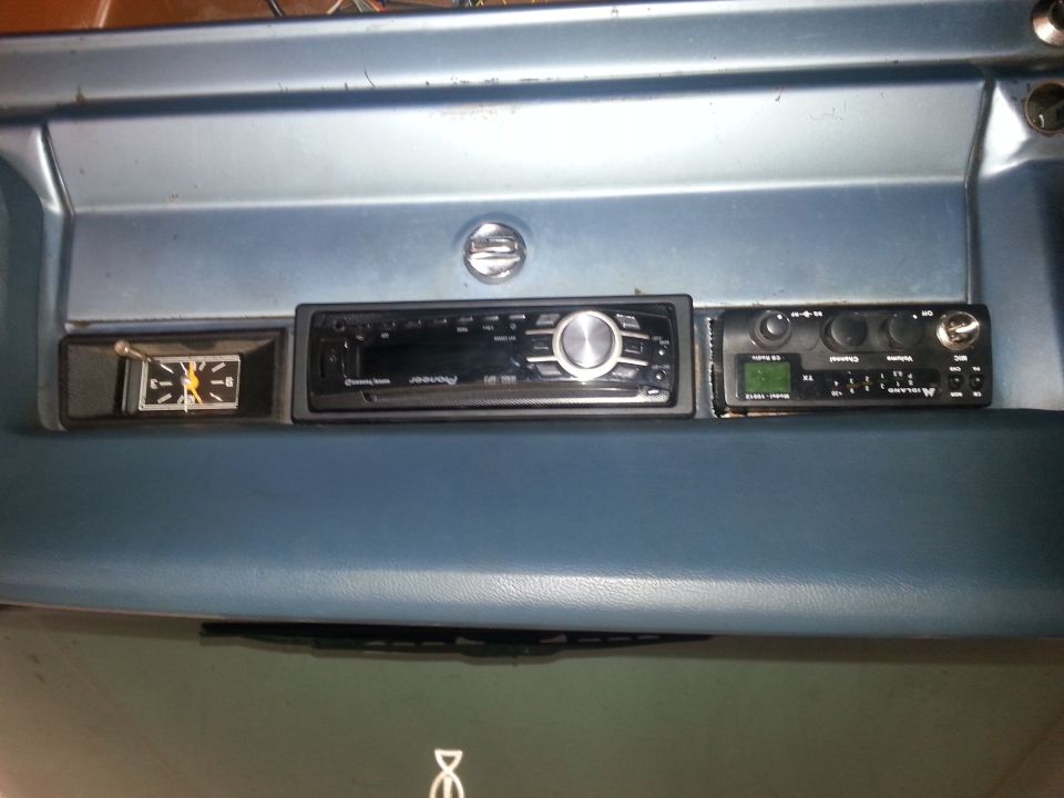 Dashboard interior showing a clock, Pioneer car stereo, and Midland CB radio