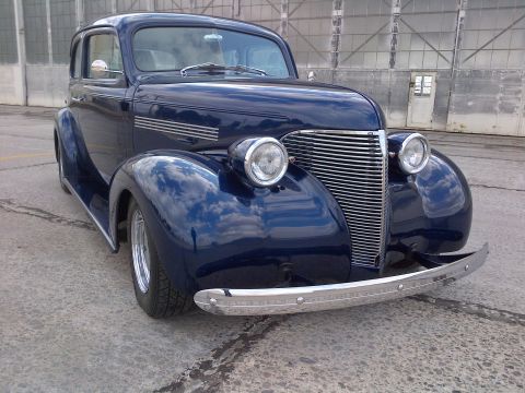 1939 Chevrolet Biscayne - This 1939 Chevrolet sedan features a distinctive chrome grille and a prominent front bumper, captured in a three-quarter front view.