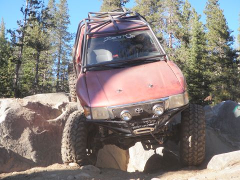 1961 International Scout 800 - This modified Toyota 4Runner navigates a rocky trail with its front end angled upwards.