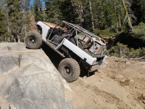 1961 International Scout 800 - This heavily modified off-road vehicle navigates a challenging rocky terrain.