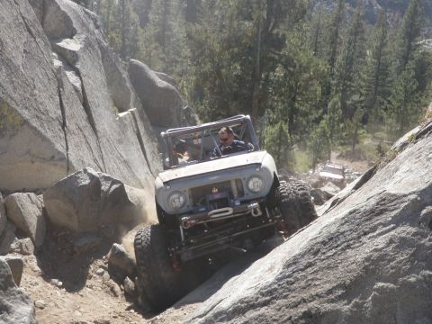 1961 International Scout 800 - This 1961 International Scout 800 navigates a challenging rocky terrain with another vehicle visible in the background.