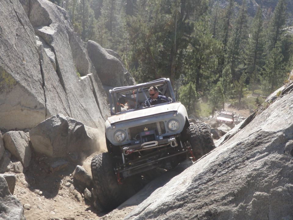 Gray 1961 International Scout 800 crawling over rocks on a trail