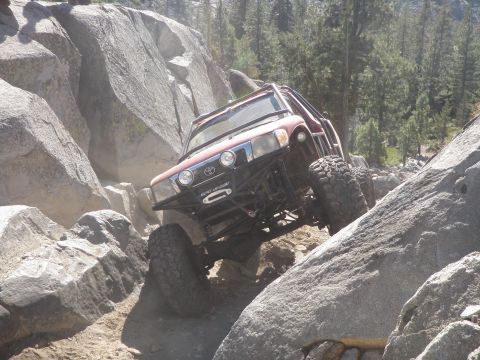 1961 International Scout 800 - Off-road vehicle tackles a challenging rock crawling course in a mountainous area.