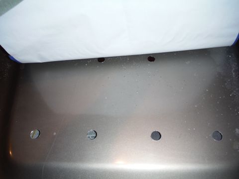 2005 Jeep Wrangler - A close-up view of a car hood with multiple holes, partially covered by white paper.
