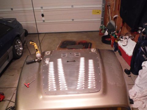 2005 Jeep Wrangler - A gold Jeep Wrangler hood, likely from a 2005 model, is shown with a drill and tools in a garage setting.