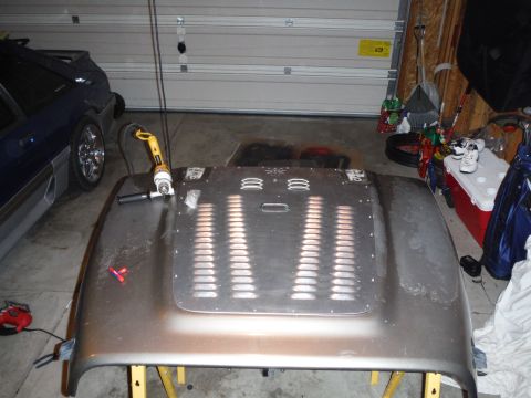 2005 Jeep Wrangler - Hood for a 2005 Jeep Wrangler with vent inserts and tools nearby.