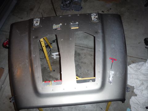 2005 Jeep Wrangler - Underside of a gray Jeep hood, showing mounting points and support structure.