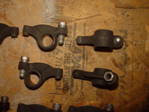 1969 Ford Fairlane - Engine rocker arms are shown on a wooden background. These parts are essential for valve operation in an internal combustion engine.