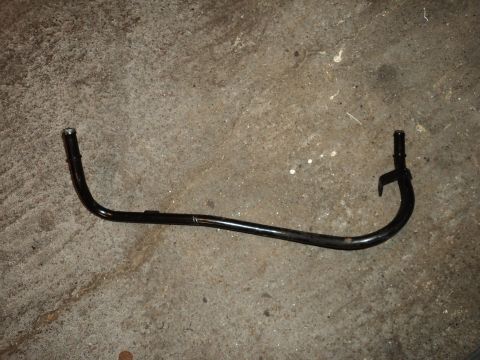 2004 Mercury Grand Marquis - A black metal hose, likely a coolant or vacuum line, lies on a concrete surface. The part has two distinct connection ends.
