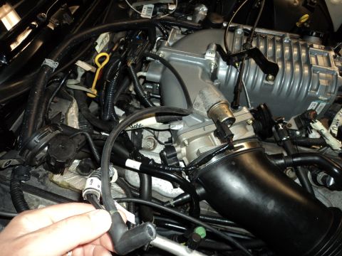 2004 Mercury Grand Marquis - Close-up of a modified engine bay, showing a supercharger and various engine components.