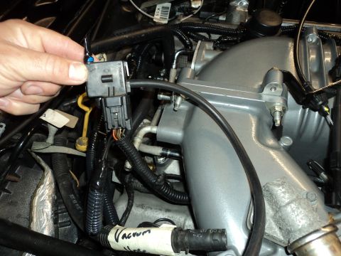 2004 Mercury Grand Marquis - Close-up of engine components, focusing on electrical connections and intake manifold.