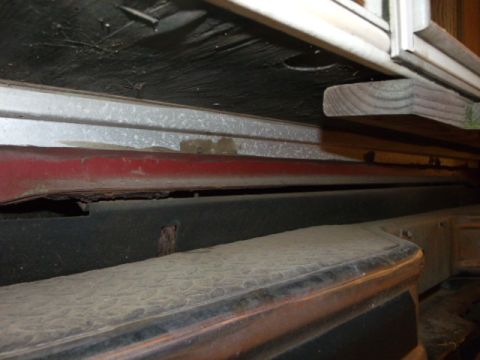 1984 Ford Bronco - Close-up of vehicle undercarriage, showing red bodywork and bumper detail. Supermotors.net logo is present.