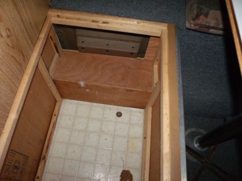 1984 Ford Bronco - This photo shows an empty storage compartment inside a vehicle, likely a camper or RV.