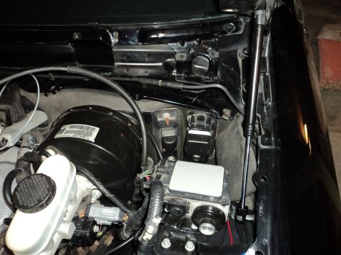 2004 Mercury Grand Marquis - Close-up view of engine bay components, including the brake booster and ABS module.