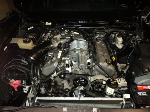 2004 Mercury Grand Marquis - Engine bay modification a supercharger. The specific vehicle model and year are not visually identifiable.