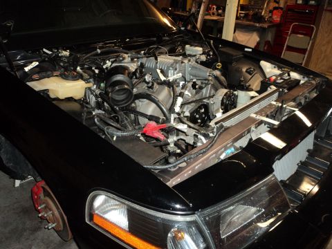 2004 Mercury Grand Marquis - The engine bay of a black car is exposed, revealing a supercharger and other engine components.