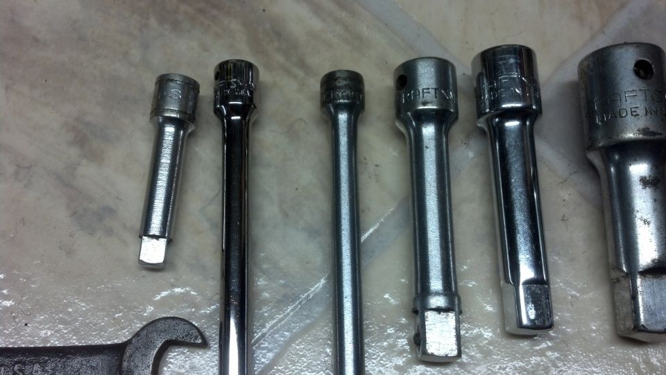 Row of six chrome socket extension bars in increasing length