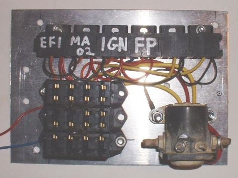 1986 Ford Bronco - A custom-mounted electrical component board with multiple fuses and a relay, labeled for various vehicle systems.