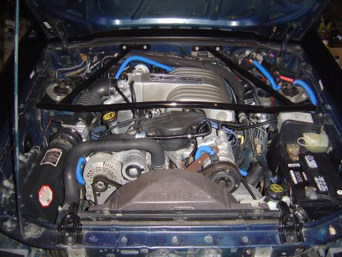 1989 Ford Mustang - Engine bay of a 1989 Ford Mustang, showing the V8 engine and aftermarket modifications.